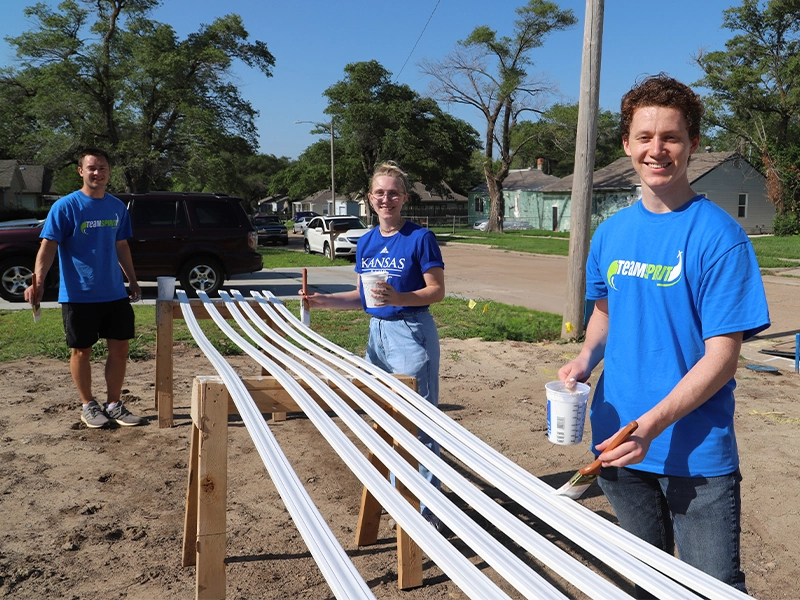 A group of Spirit AeroSystems interns painting.