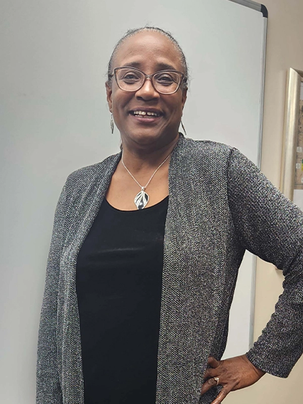 Family partner Kathy standing in front of a white board.