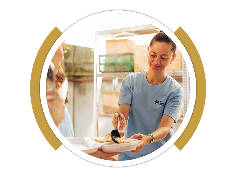 A person pouring food into a tray.