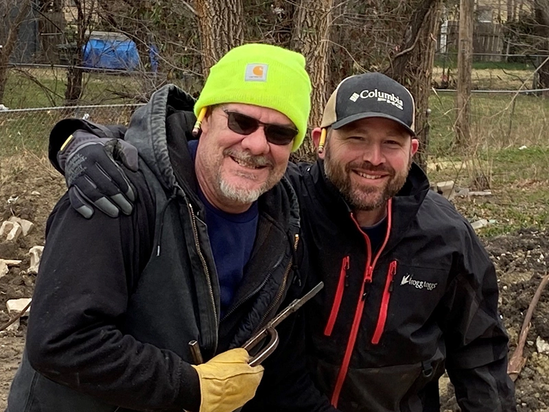 Troy Martin smiling with another volunteer.