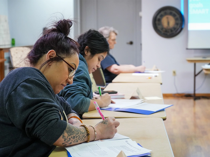 Class participants writing down notes.
