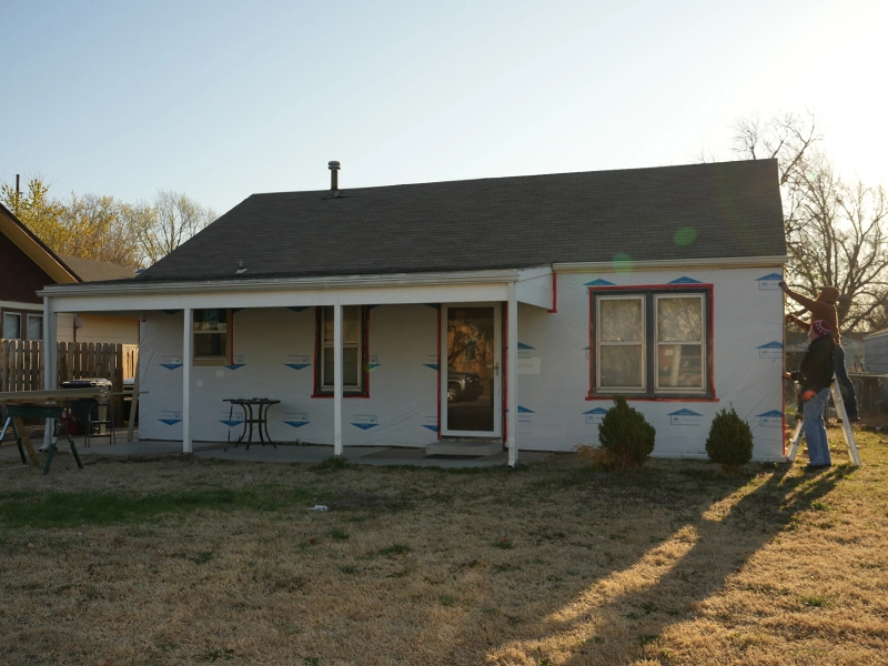 A house having its siding replaced.
