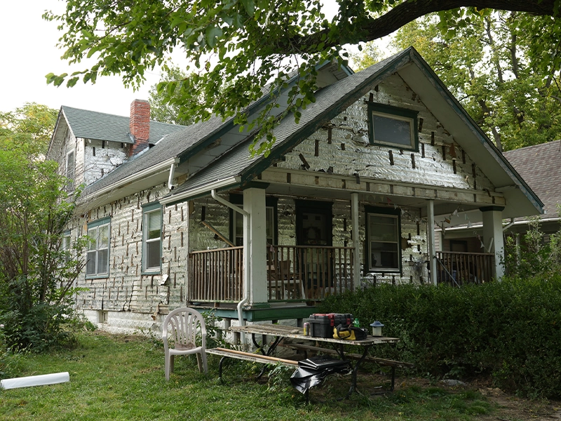 A house having its siding replaced.