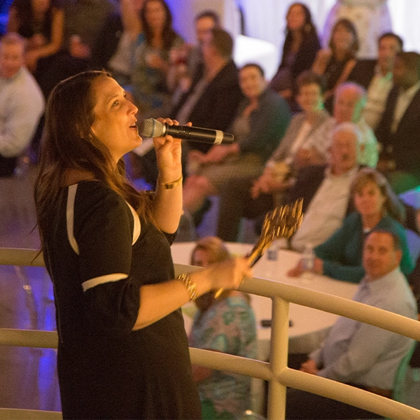 An auctioneer speaking on the microphone.