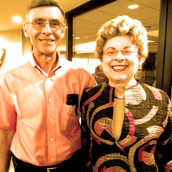 Charlie and wife smiling together.