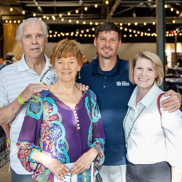 Two couples smiling together.